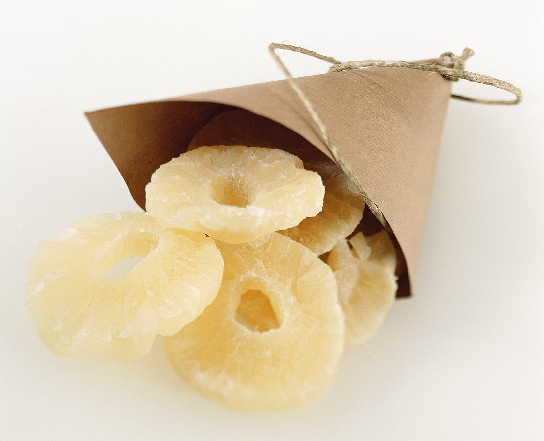 Candied pineapple slices in paper bag