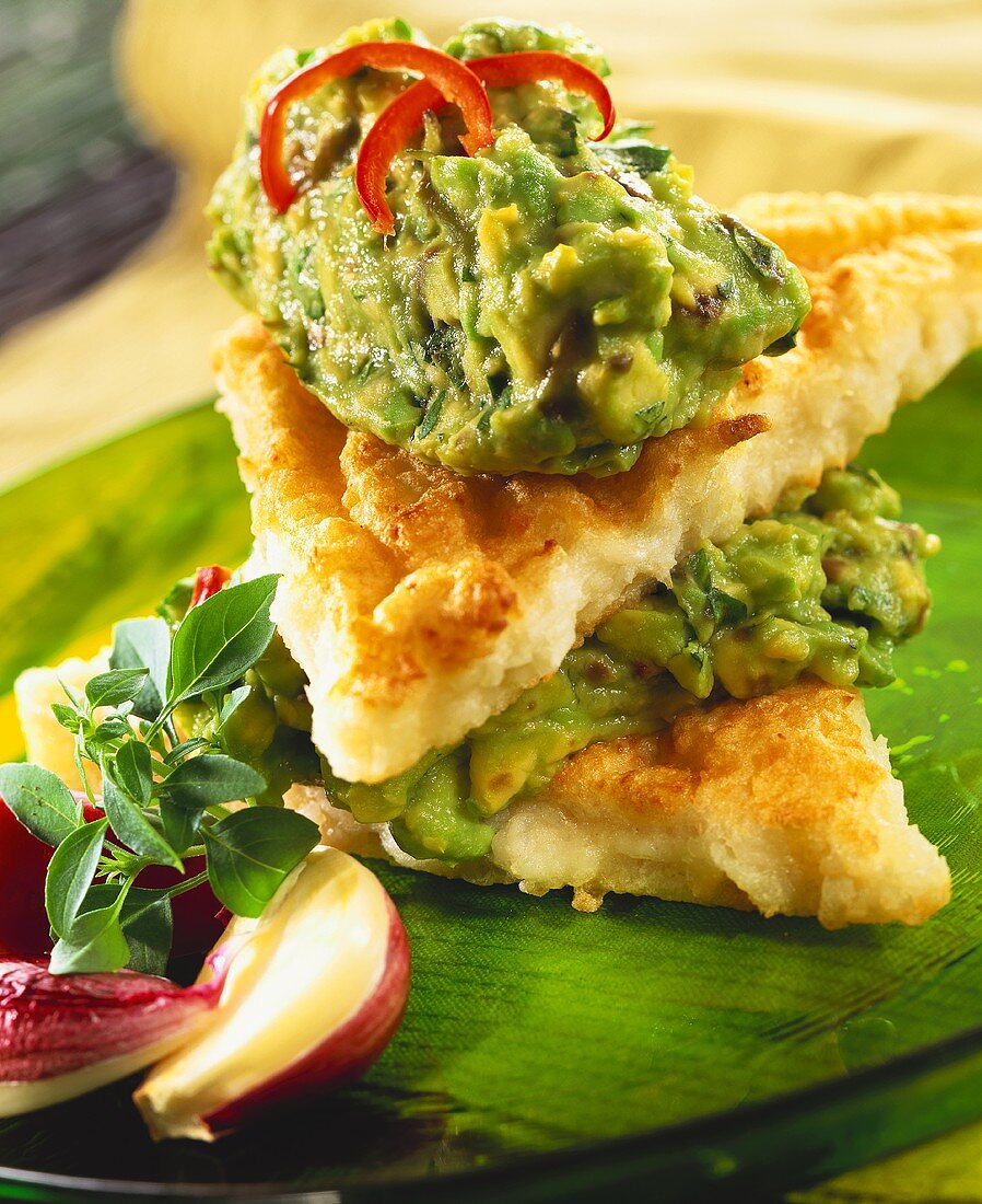 Fried bread with coconut, sandwiched with guacamole