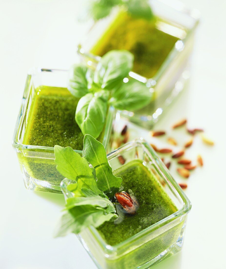 Three types of pesto in glass bowls