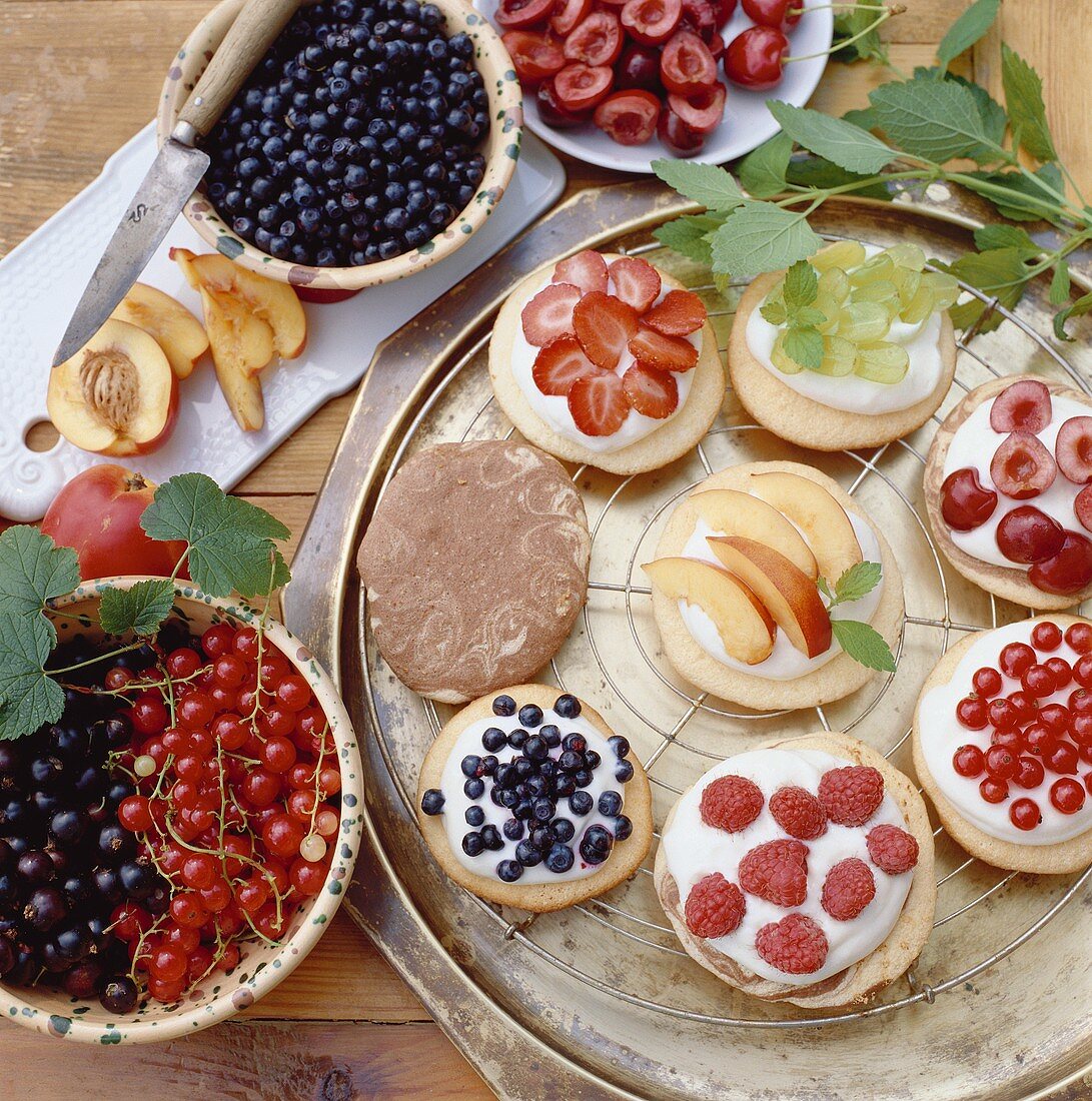 Assorted small sponge cakes with berries and fruit