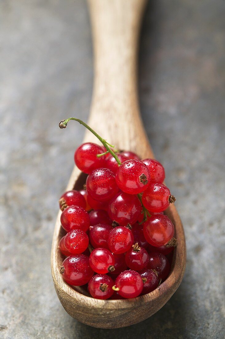 Redcurrants on wooden spoon