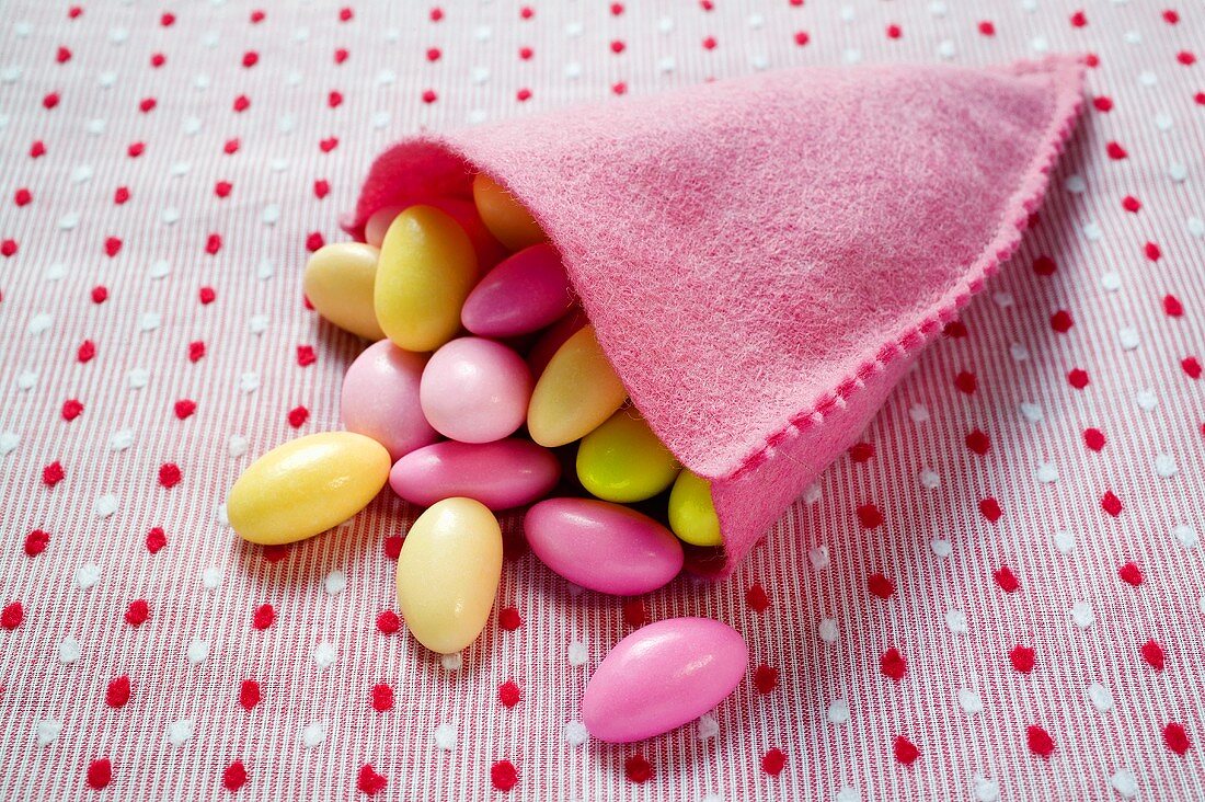 Sugared almonds in pink felt bag