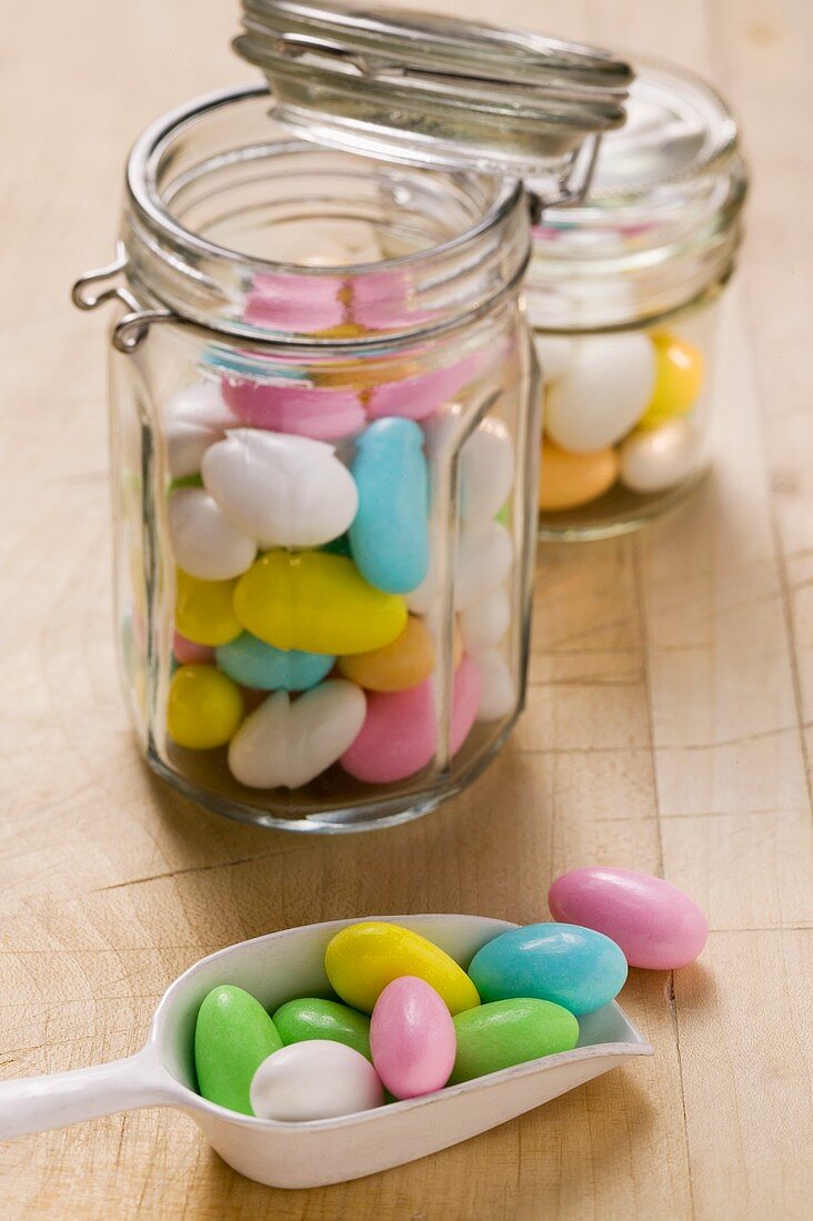 Sugared almonds in storage jars and on scoop