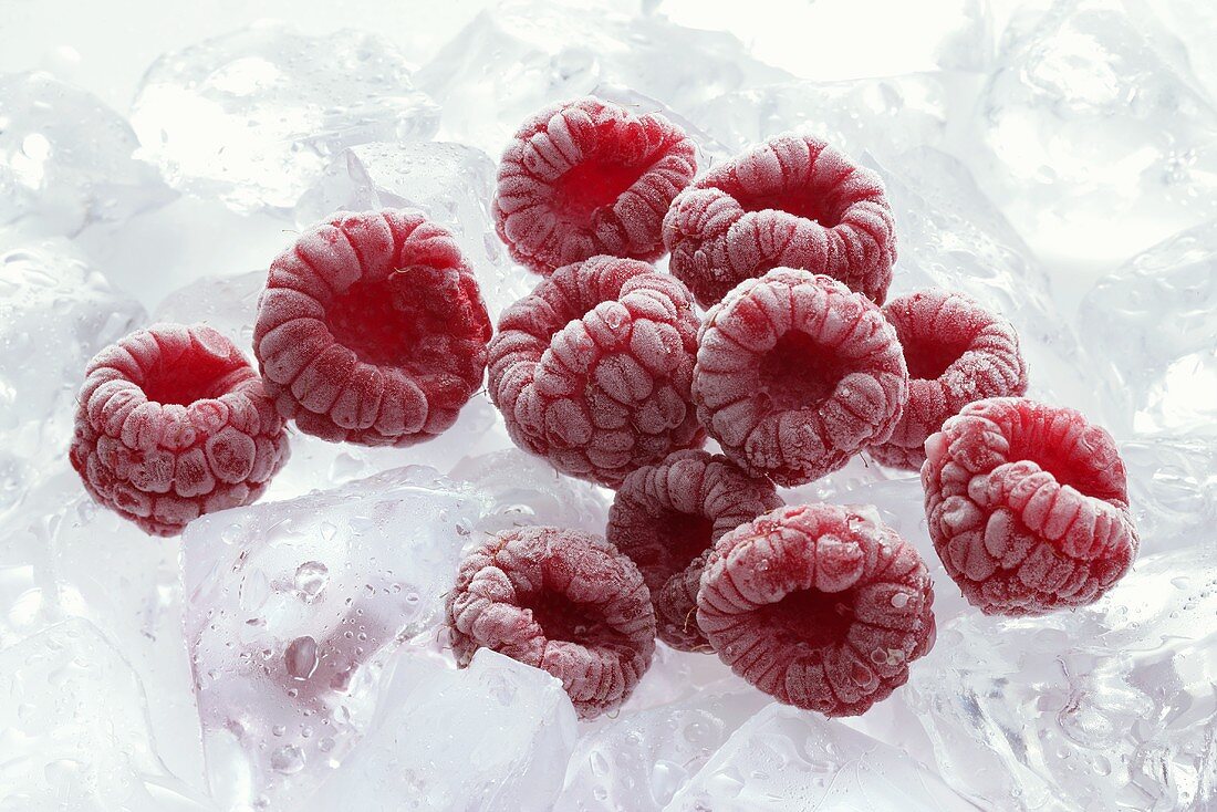Frozen raspberries on ice cubes