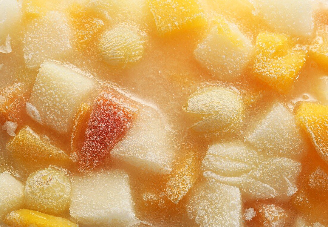 Frozen fruit in block of ice (full-frame)