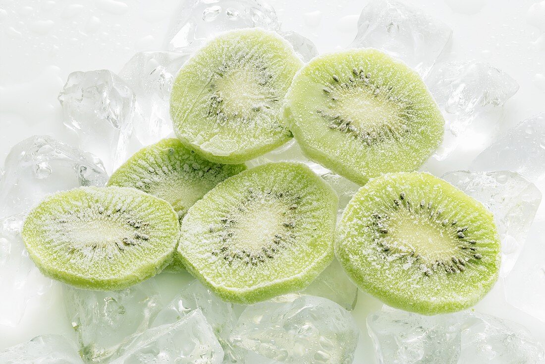 Frozen kiwi fruit slices on ice cubes