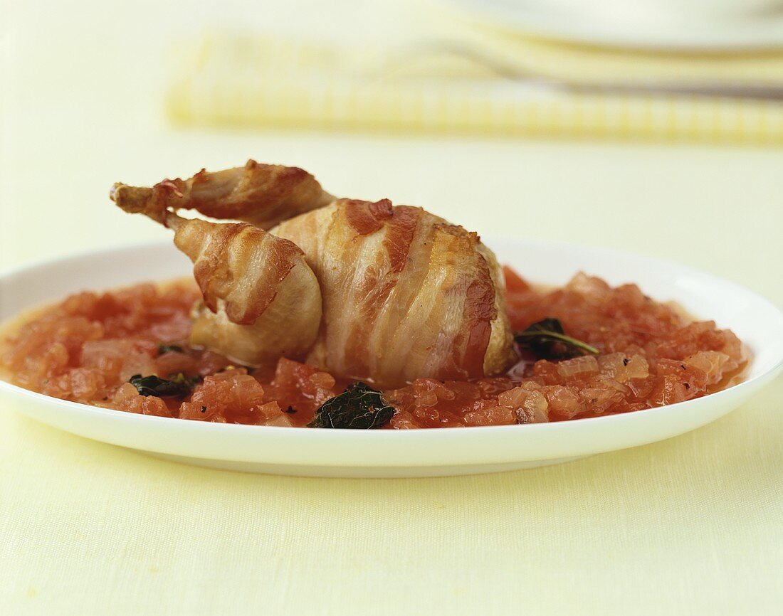 Quail wrapped in bacon with watermelon sauce