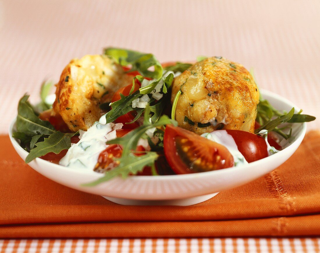 Tomato and rocket salad with fried cheese dumplings