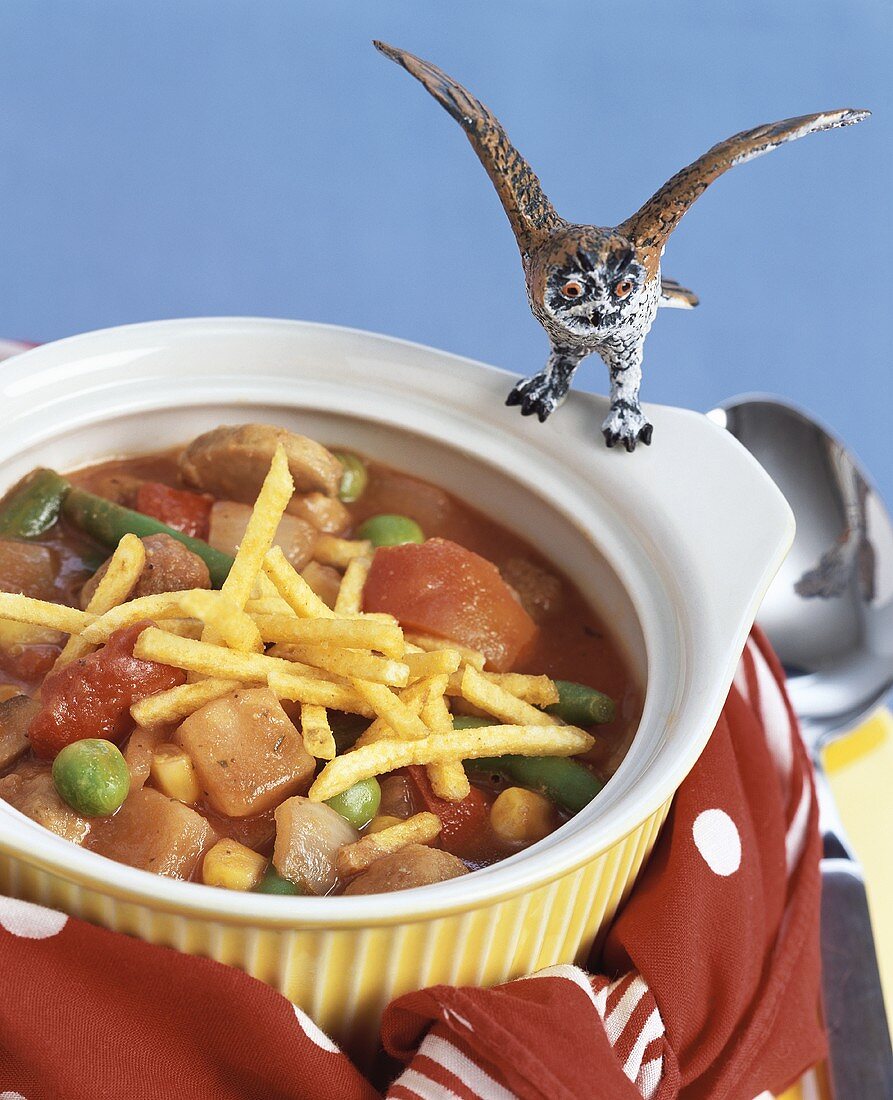 Sausage and vegetable stew with chips for children