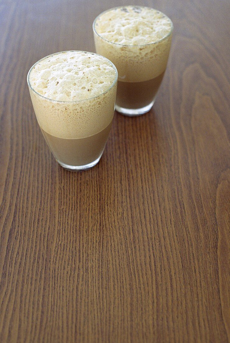 Two glasses of coffee with milk froth