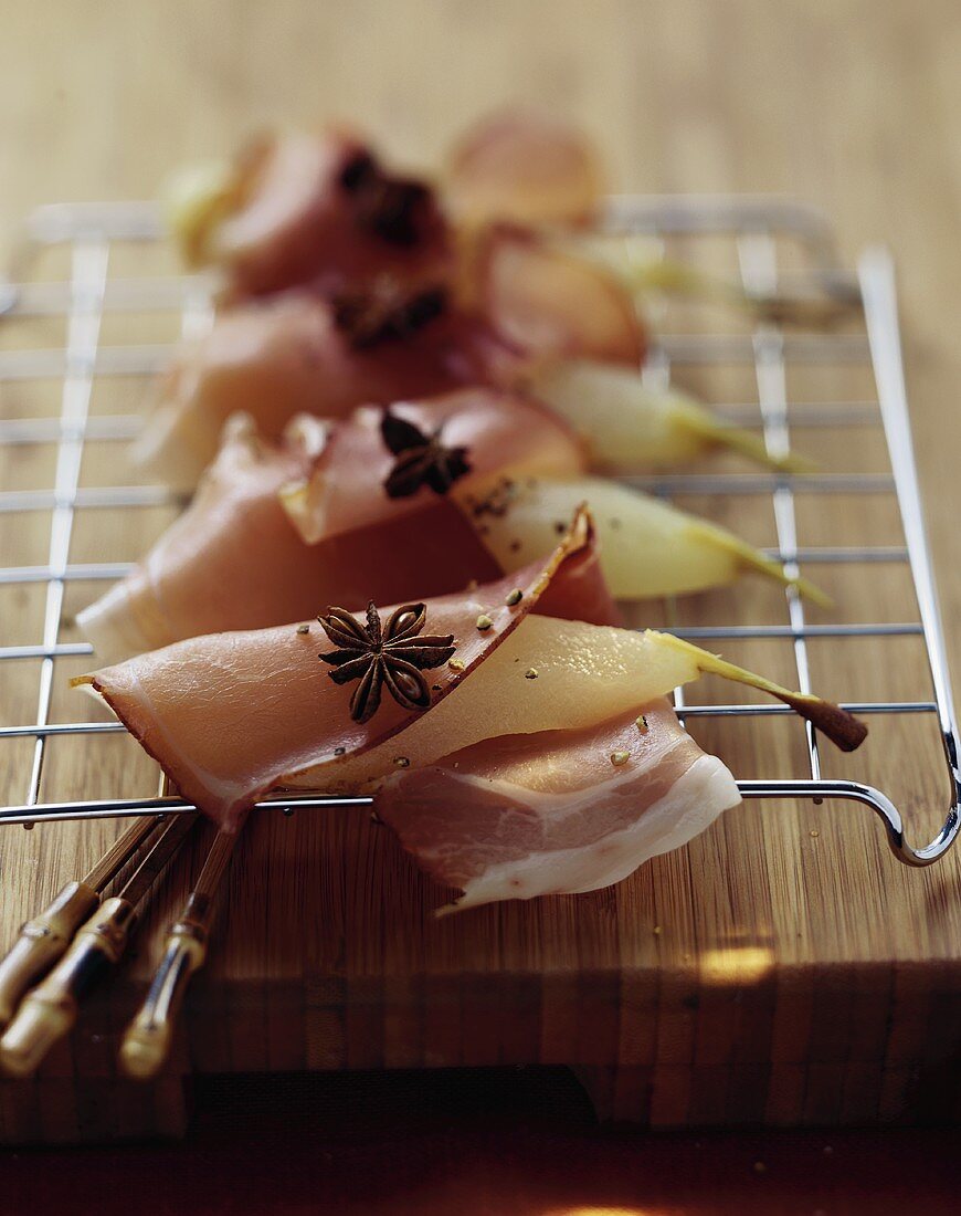 Pears wrapped in ham with star anise
