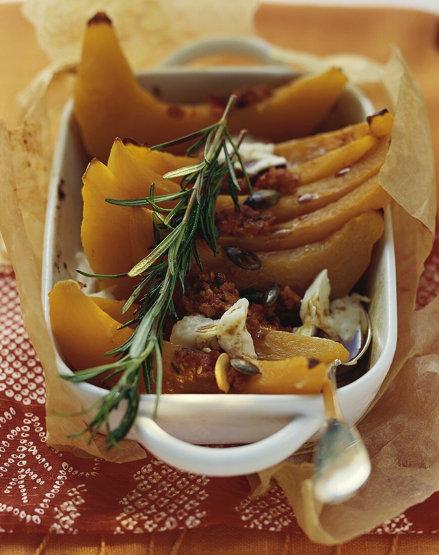 Oven-baked pumpkin slices with chilli paste and rosemary