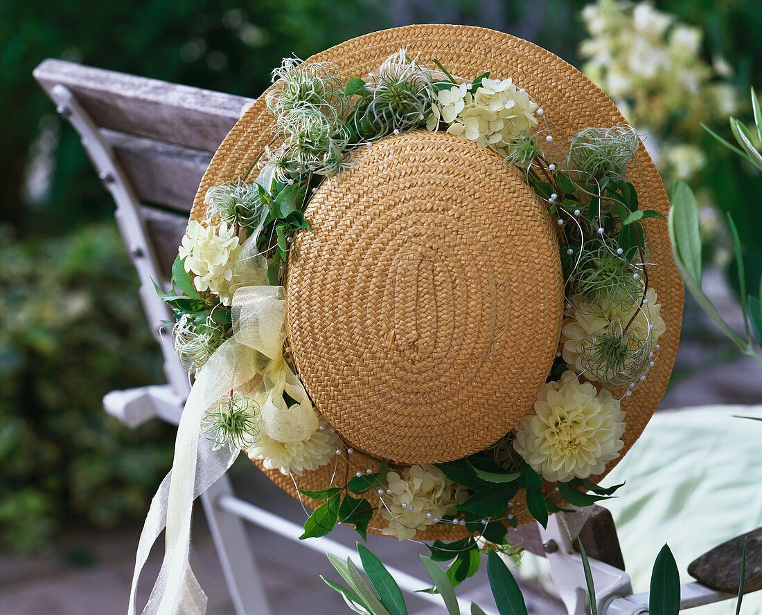 Straw hat with wreath of white dahlias and clematis