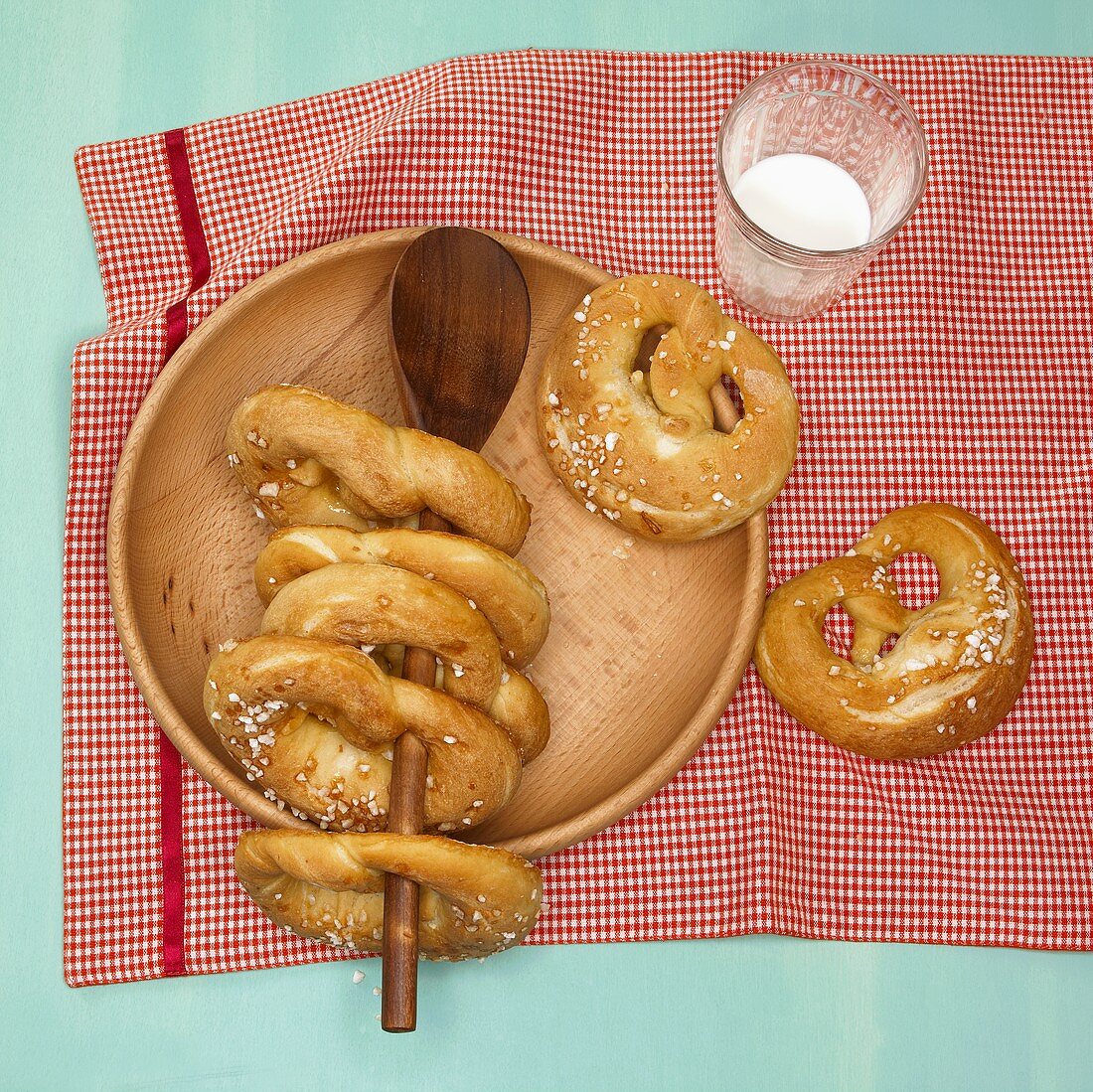 Pretzels on wooden plate and wooden spoon