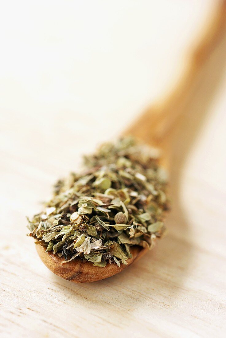 Dried oregano on wooden spoon