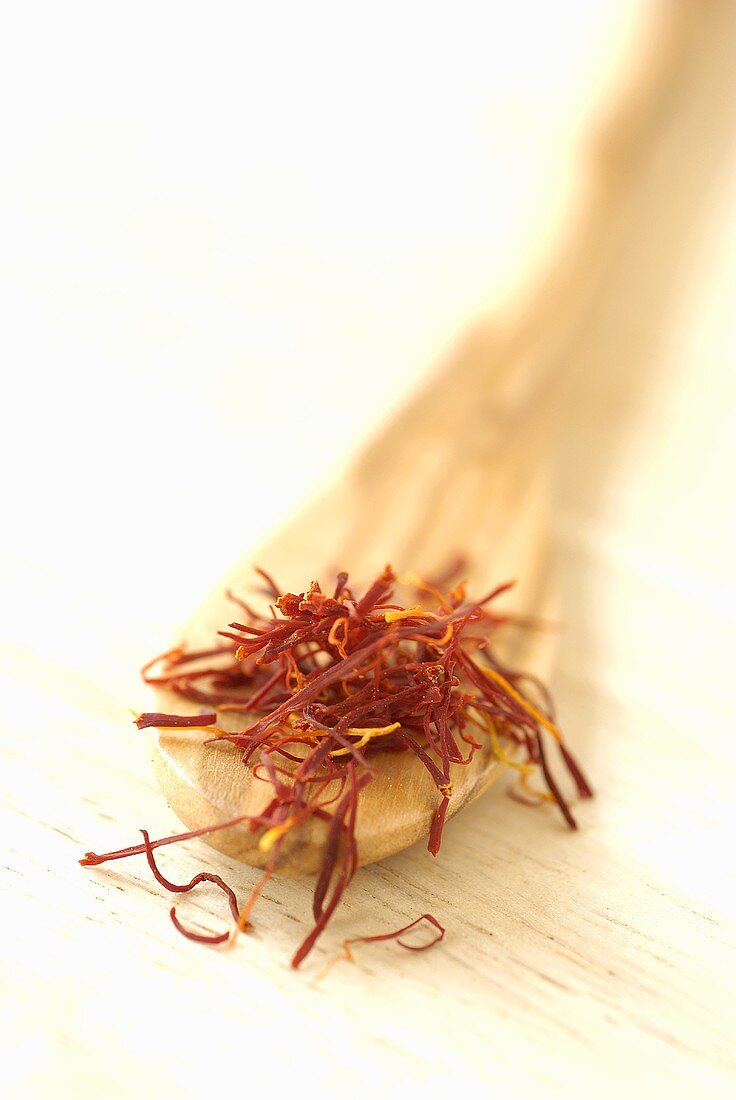Saffron threads on wooden spoon