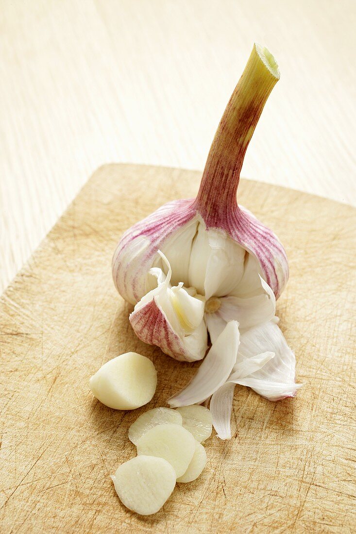 Garlic bulb and clove of garlic, partly sliced