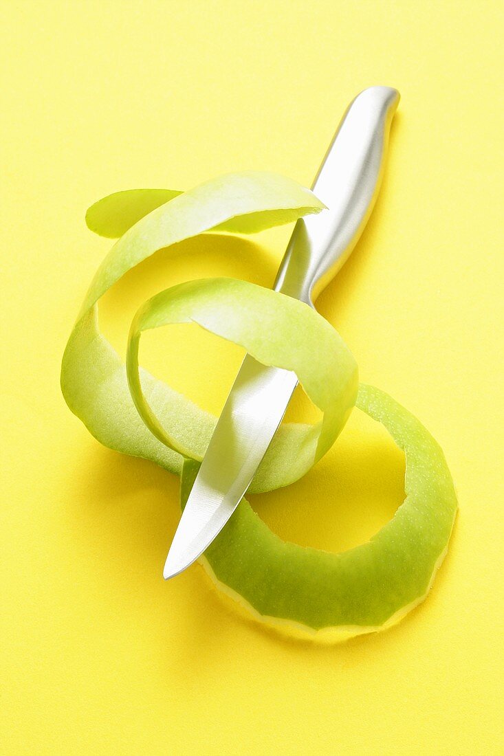 Green apple peel with knife