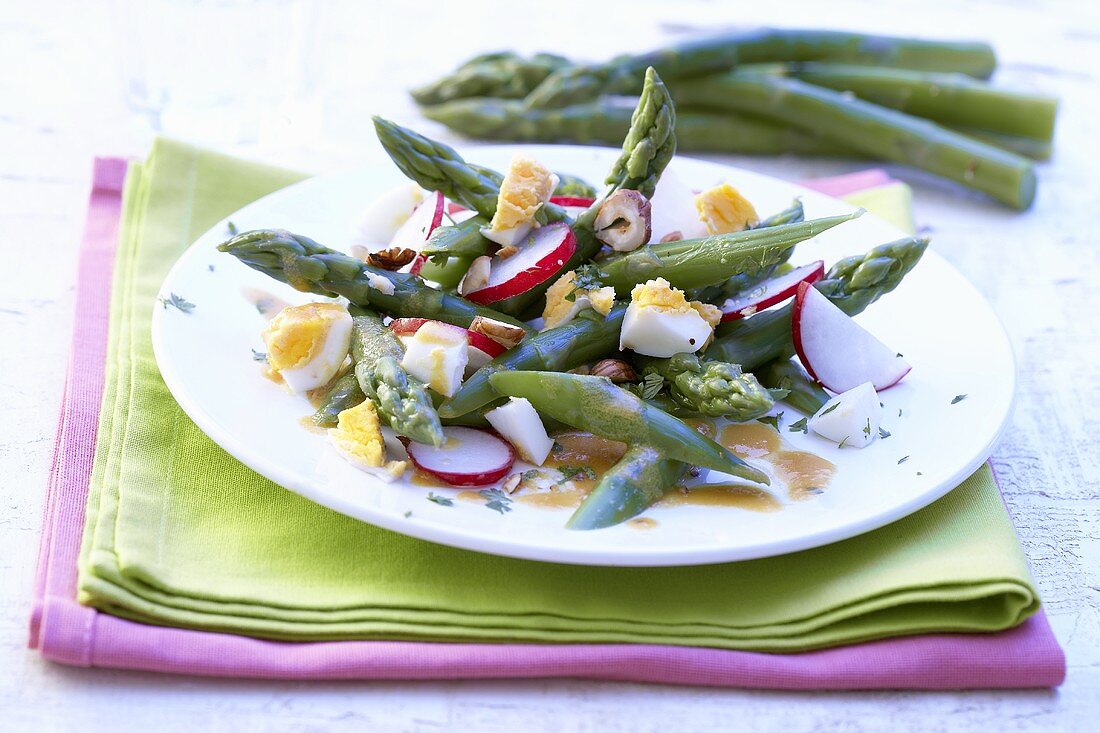 Green asparagus salad with radishes and egg