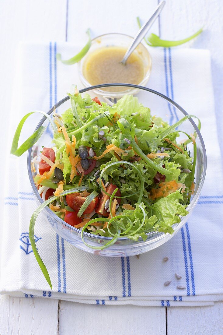 Mixed salad leaves with tomatoes & carrots, salad dressing