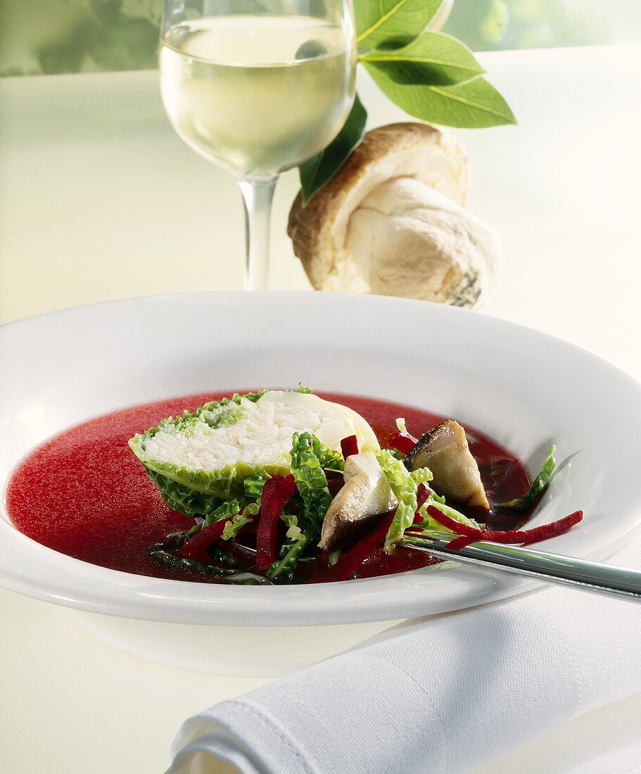 Fish consommé with beetroot and halibut roulade