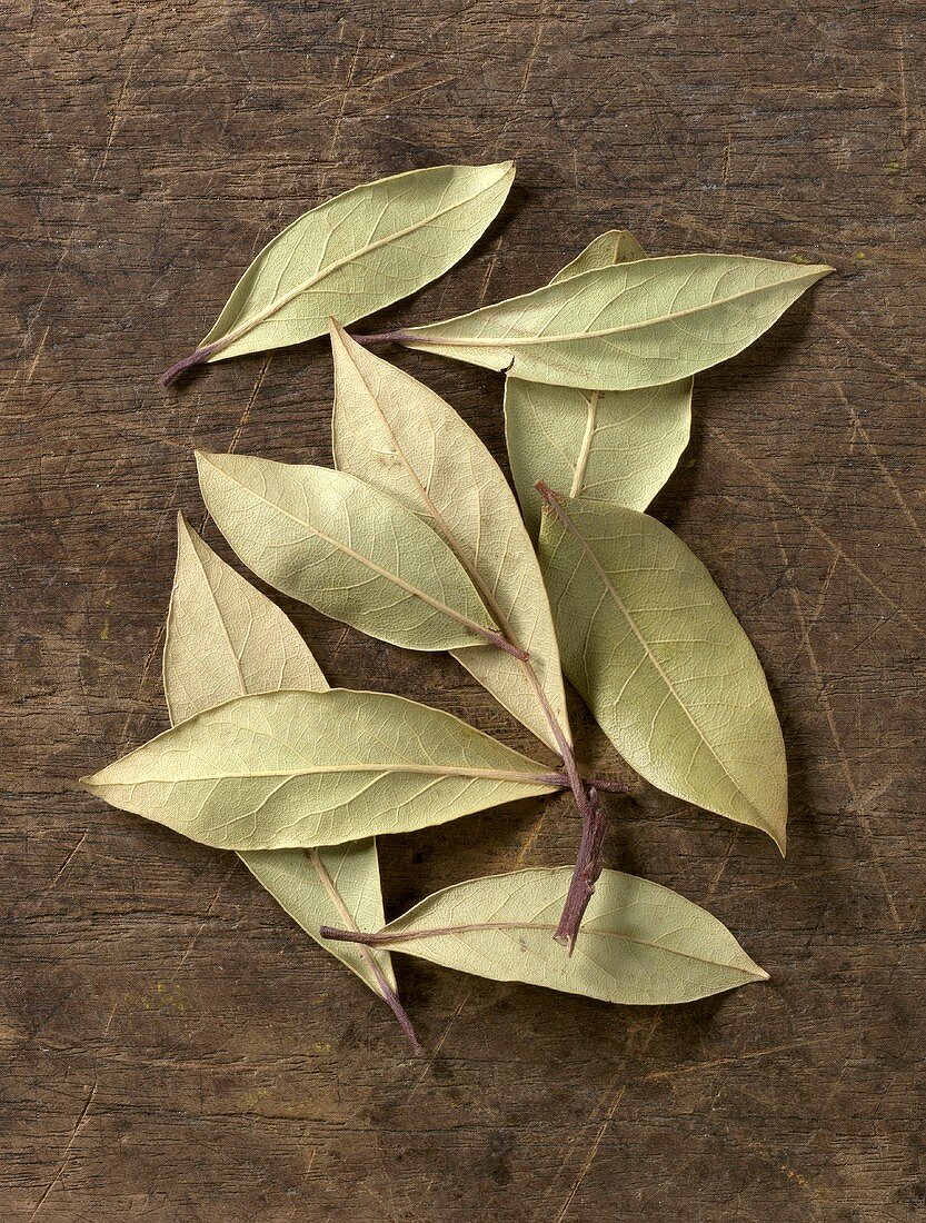 Bay leaves on wooden background
