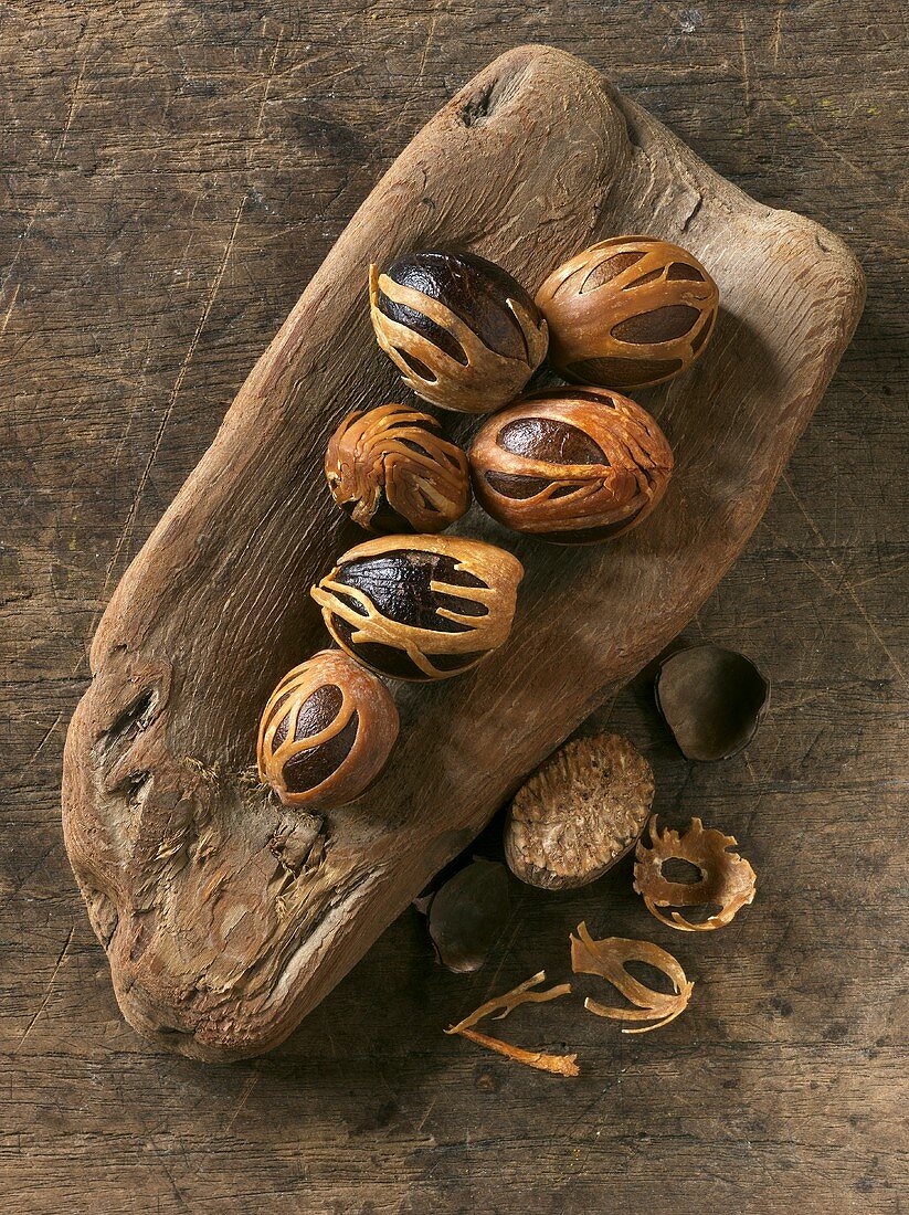 Nutmegs on wooden background