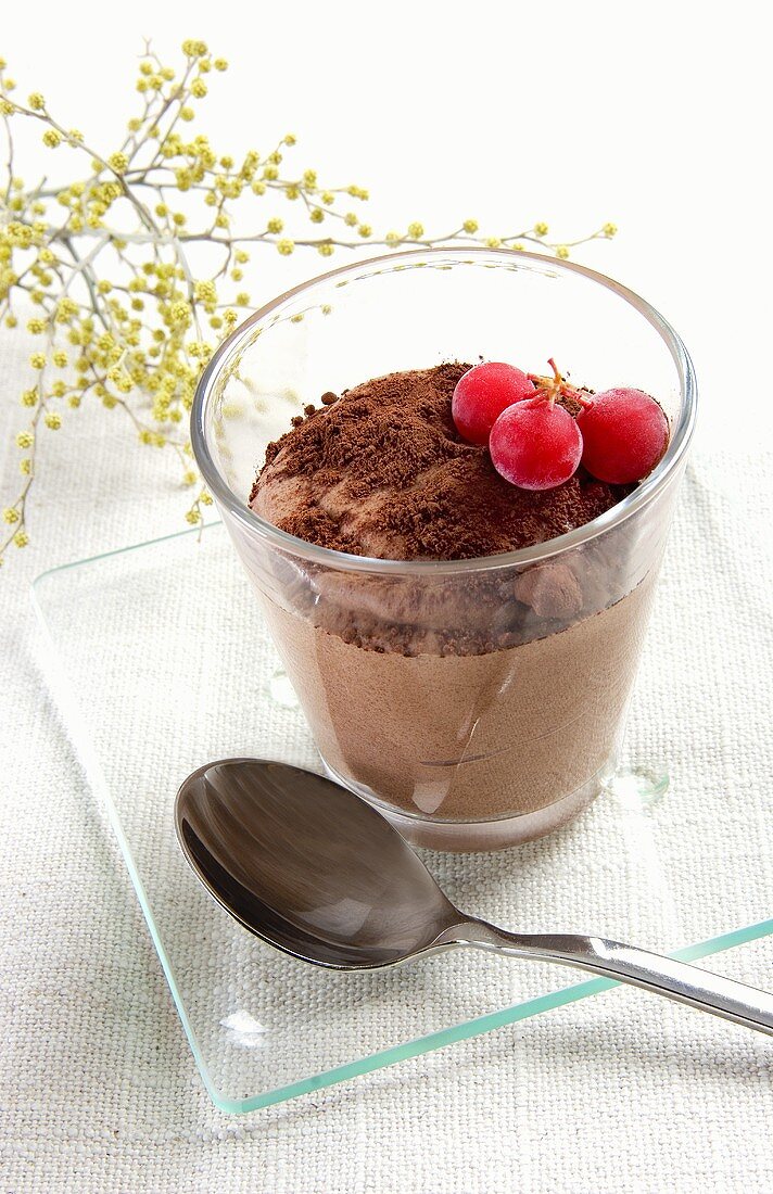 Chocolate mousse with frozen berries in glass
