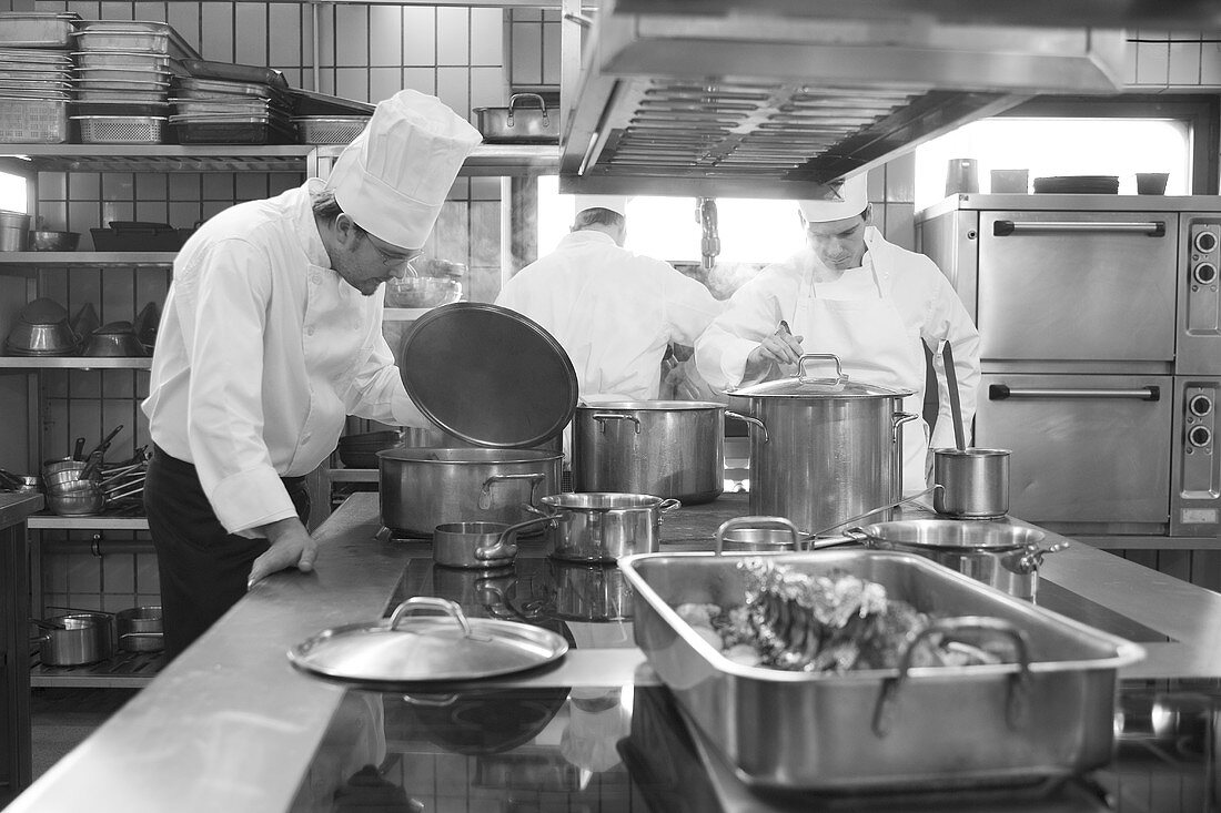 Chef examining the contents of a pan