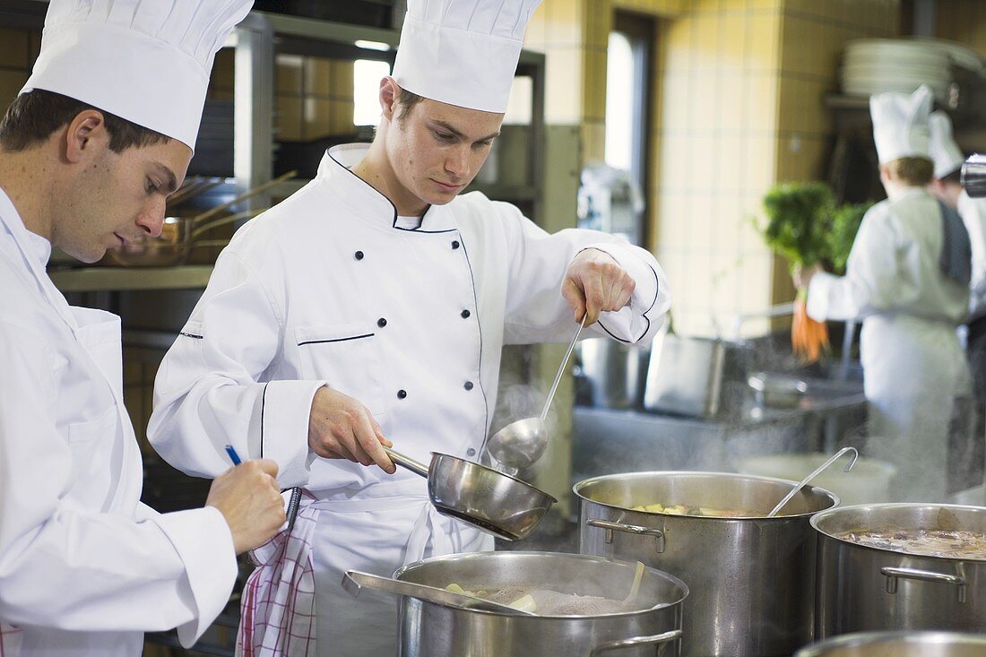 Chef ladling stock into a pan