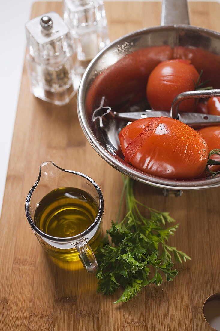 Blanched tomatoes in bowl, olive oil, parsley