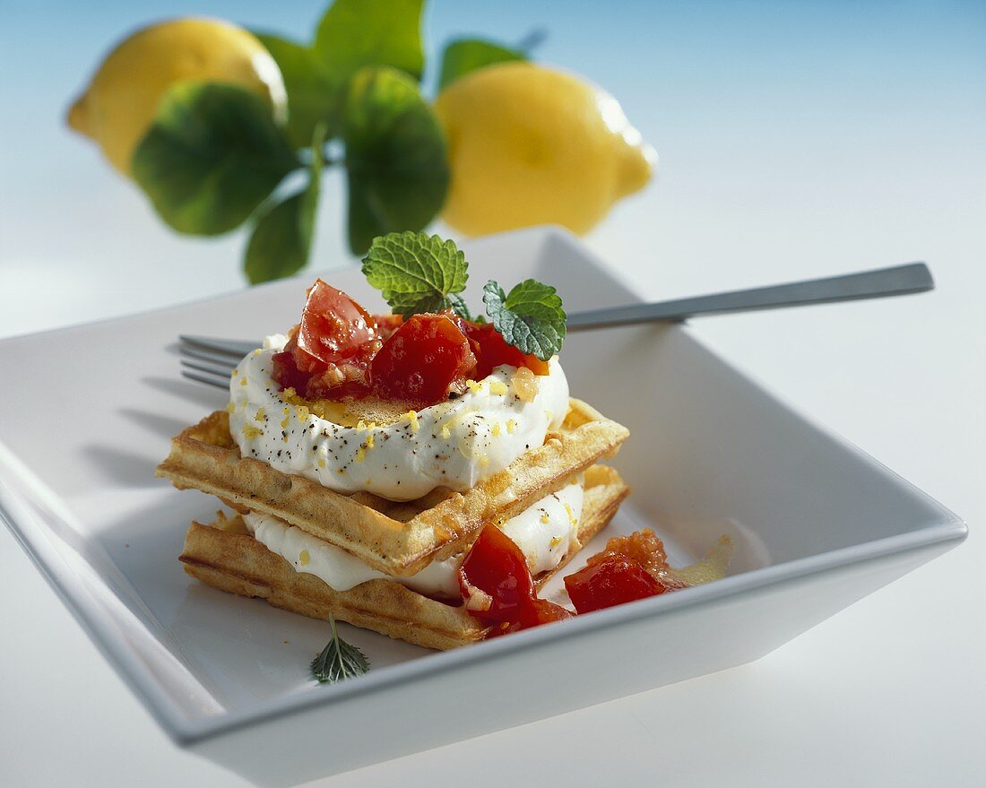 Waffles with lemon soft cheese and tomatoes