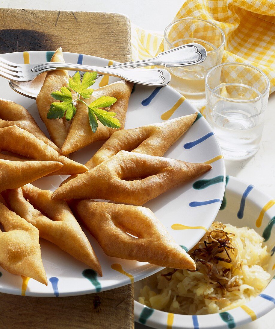 'Rabbit ears' (deep-fried pastries) with sauerkraut