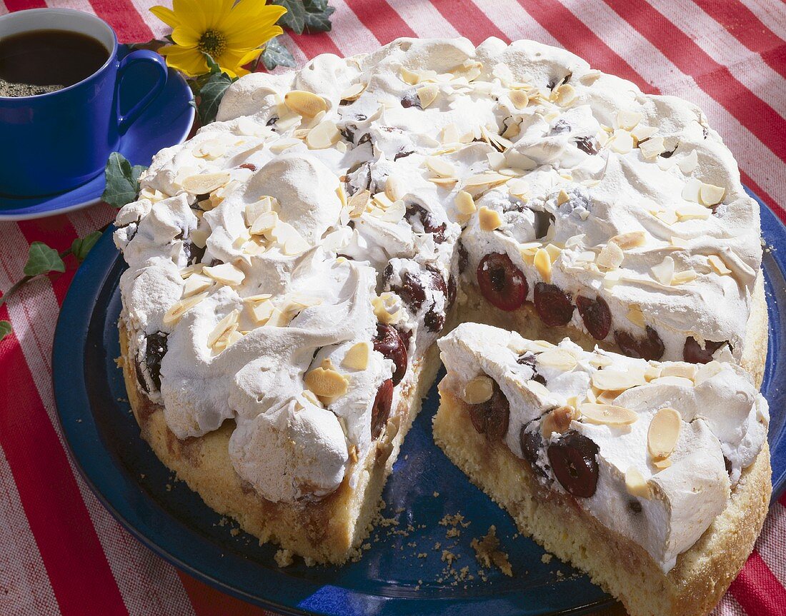 Cherry cake with meringue and flaked almonds