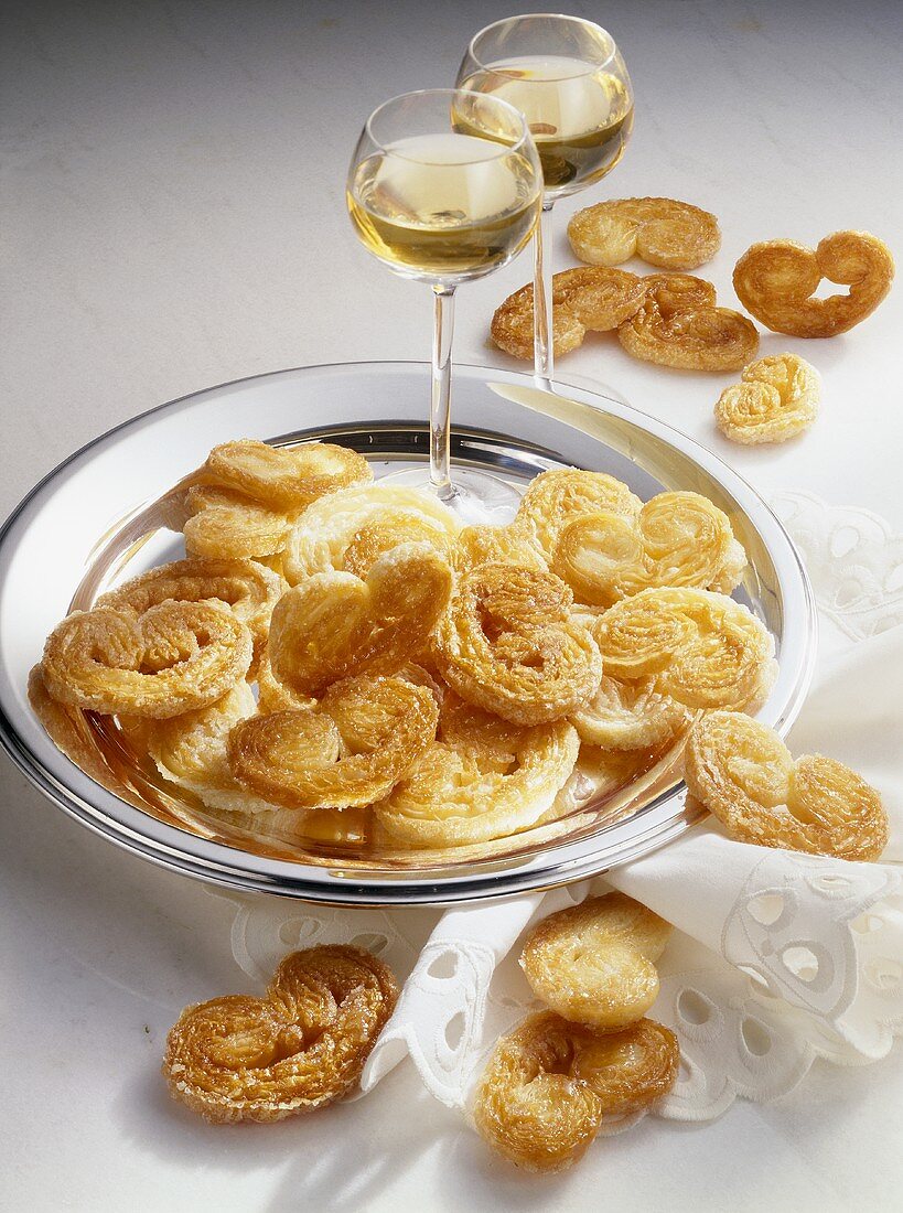 Pig's ear pastries (puff pastry) with two glasses of wine