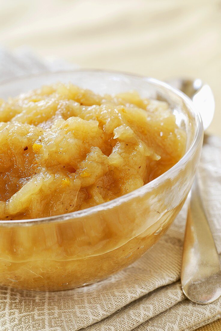 Apple and orange compote in glass bowl