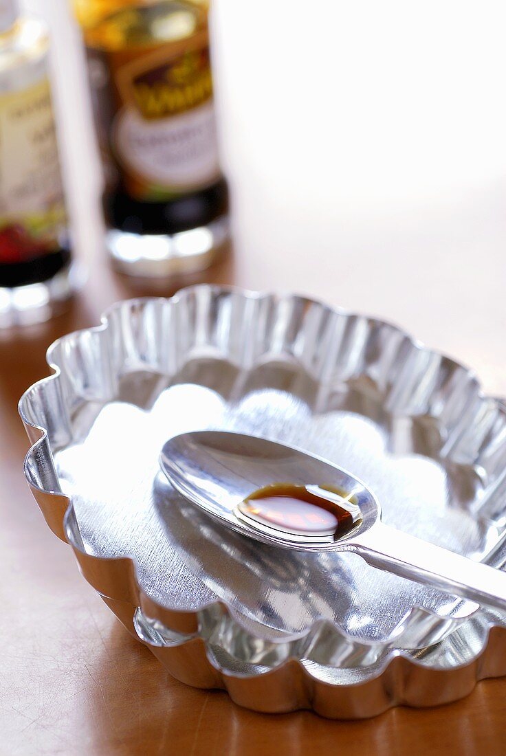 A spoonful of vanilla extract in baking tin