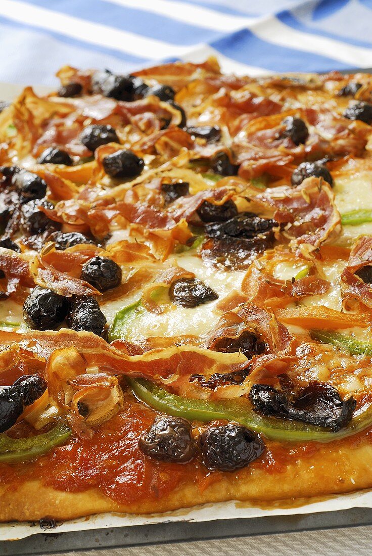 Pancetta and pepper pizza with olives (detail)