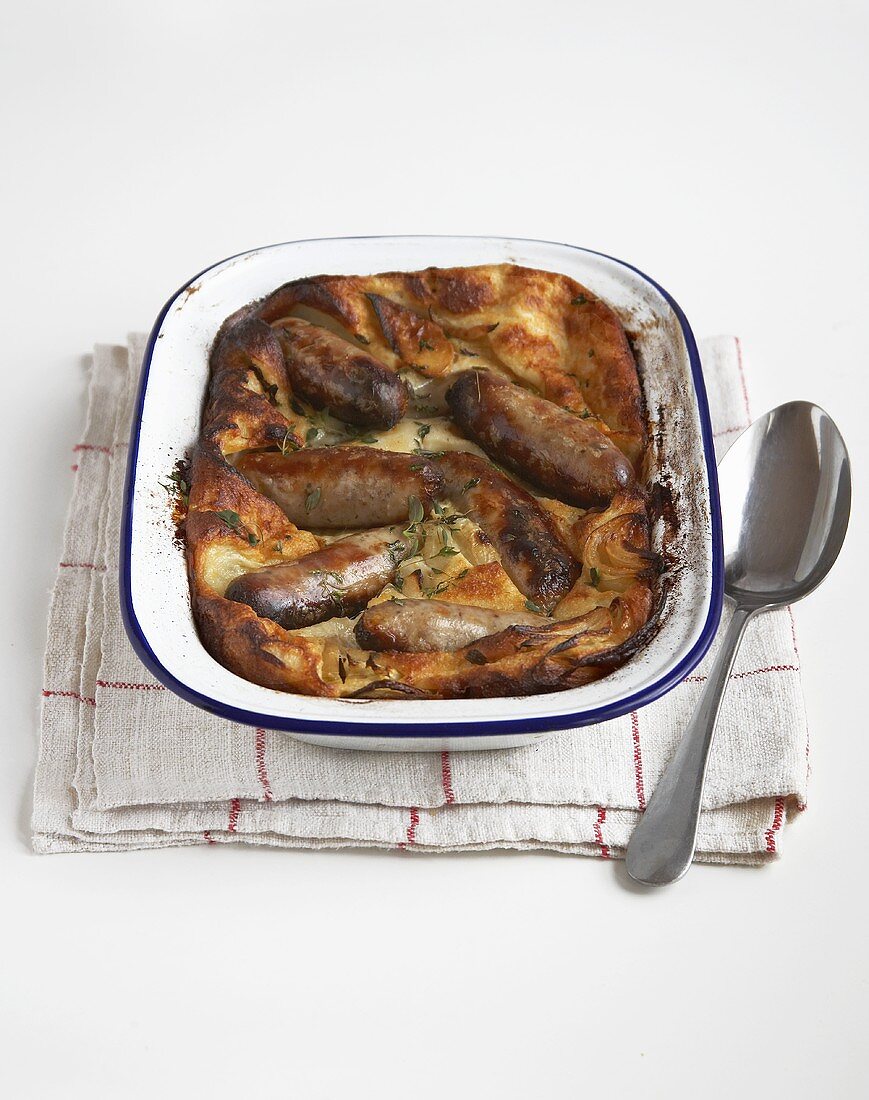 Toad in the hole (sausages baked in batter; England)