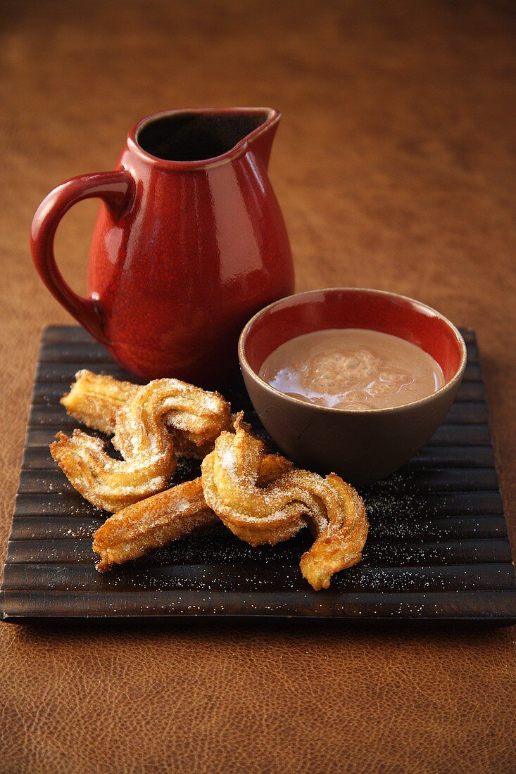 Churros (deep-fried pastries) with chocolate sauce