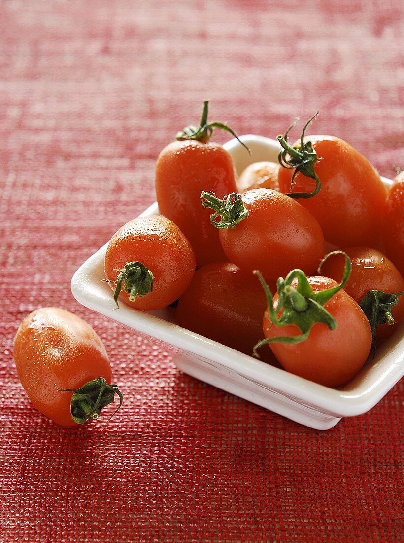Fresh grape tomatoes in white bowl