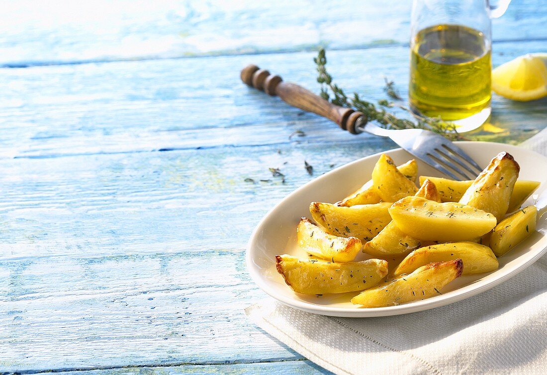 Oven-baked potatoes with thyme, olive oil, lemon (Greece)