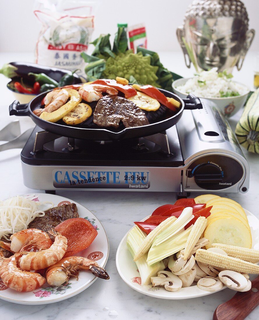 Meat, shrimps and vegetables on table grill (Asia)
