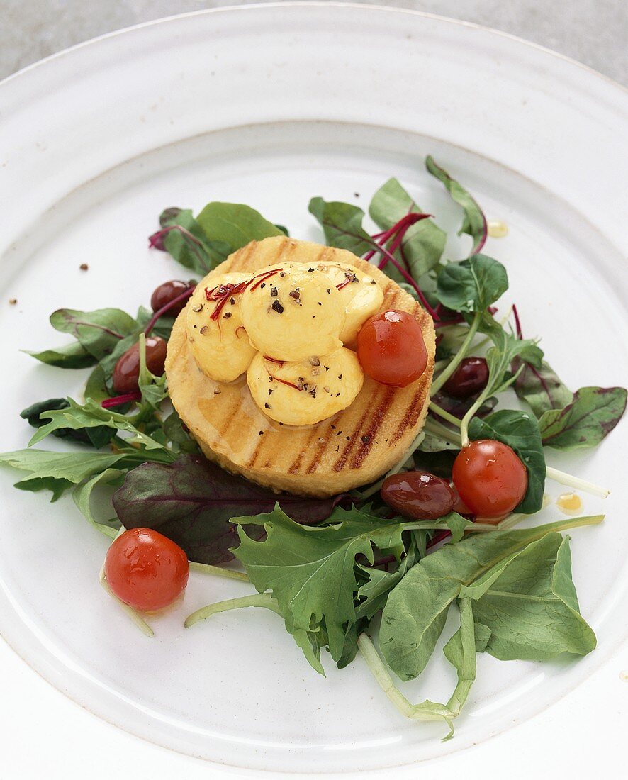 Salad leaves with polenta cake & saffron mozzarella (Italy)