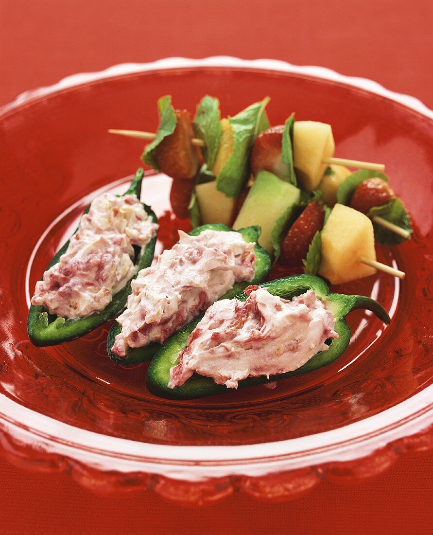 Chili peppers stuffed with raspberry cream, skewered fruit