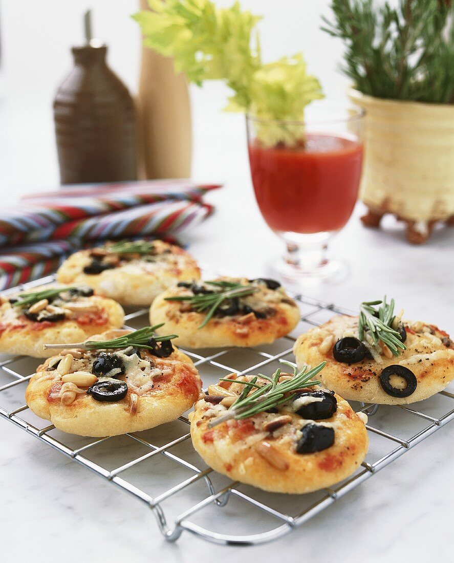 Mini-pizzas with anchovies, olives and rosemary