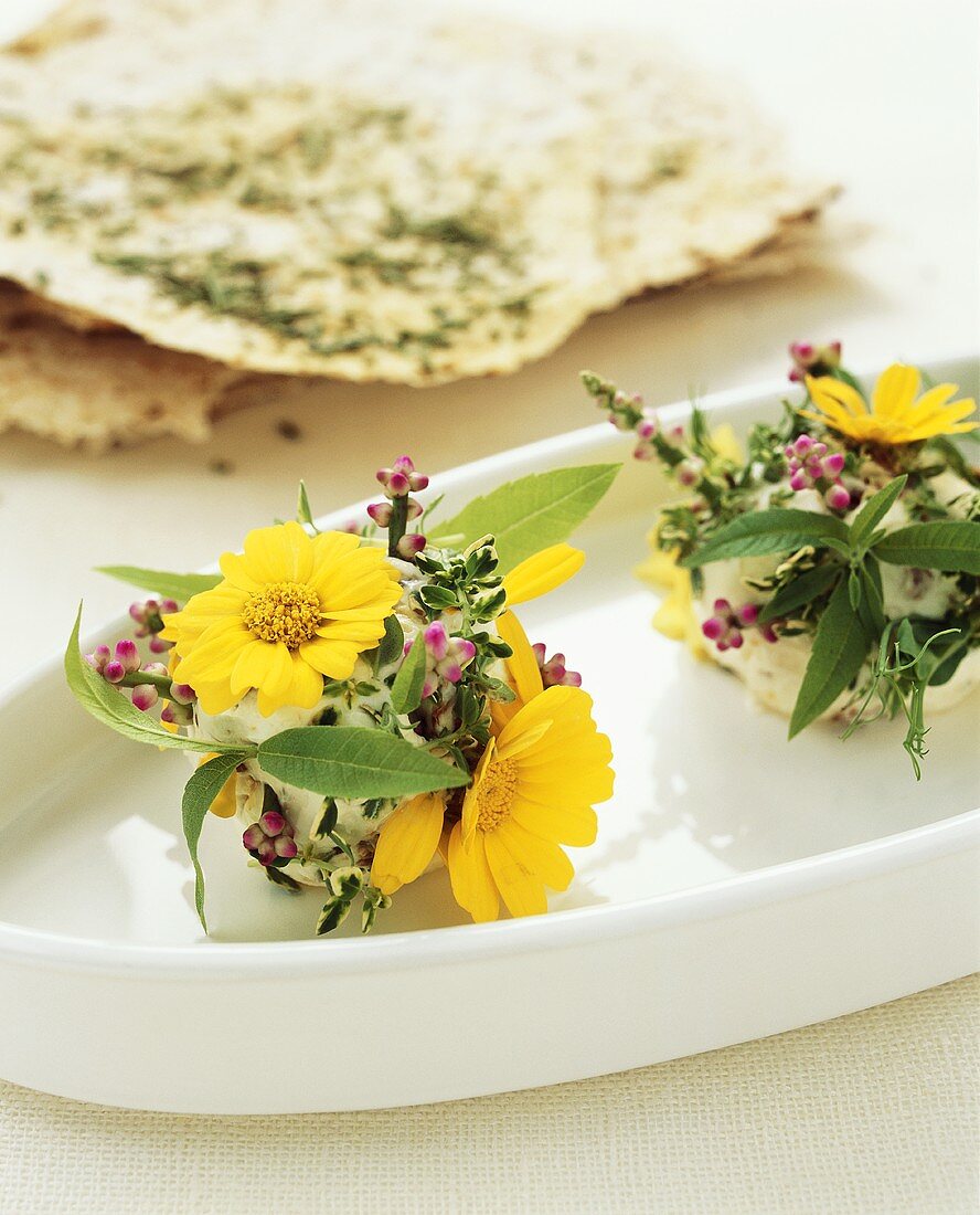 Soft cheese with herbs and edible flowers, flatbread
