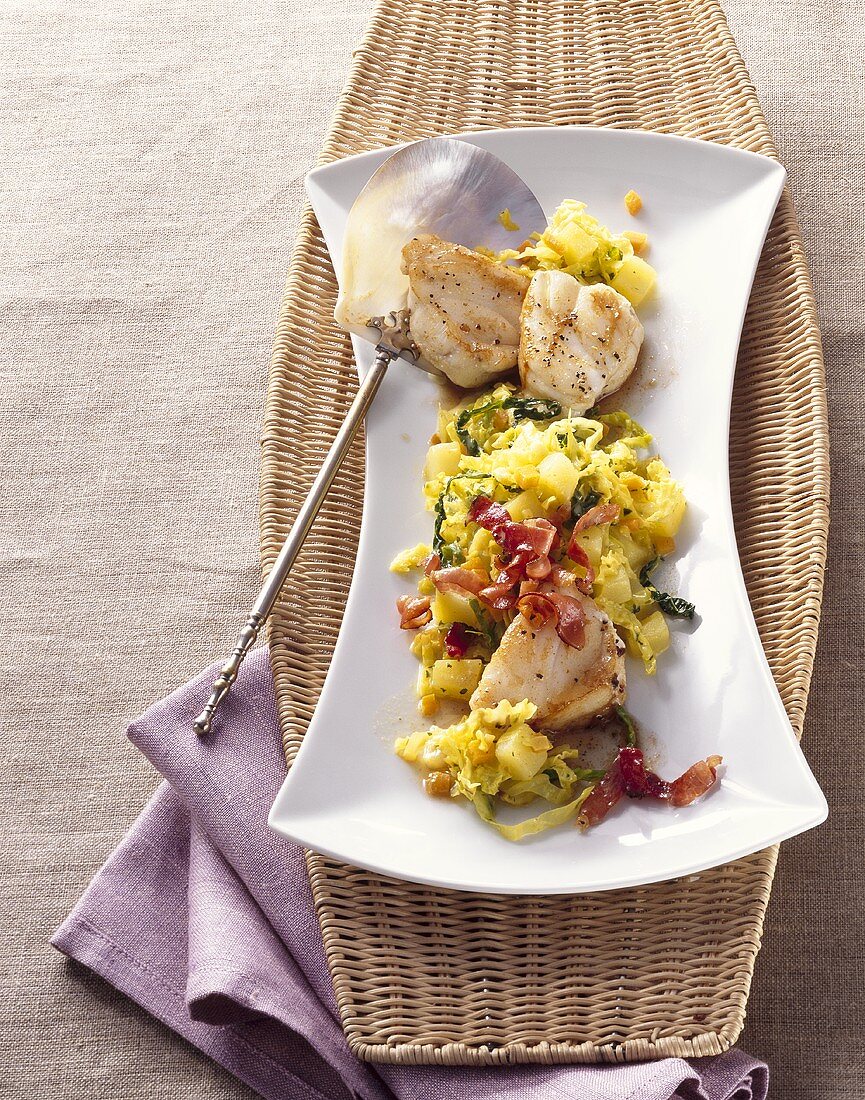 Monkfish medallions on creamed curried savoy