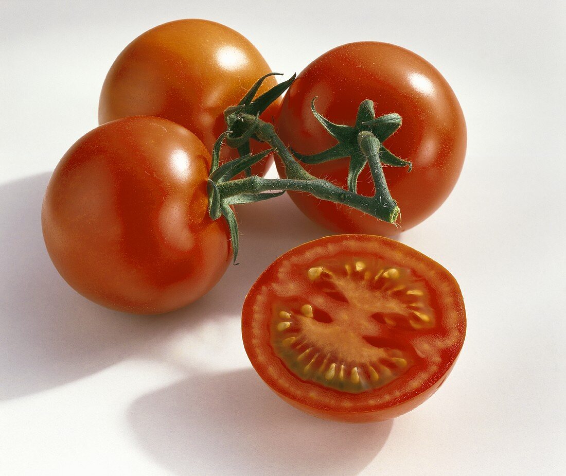 Three whole tomatoes and one tomato half