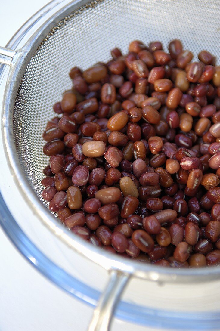 Soaked red beans in sieve